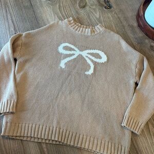Cozy Tan Sweater with White Bow Design